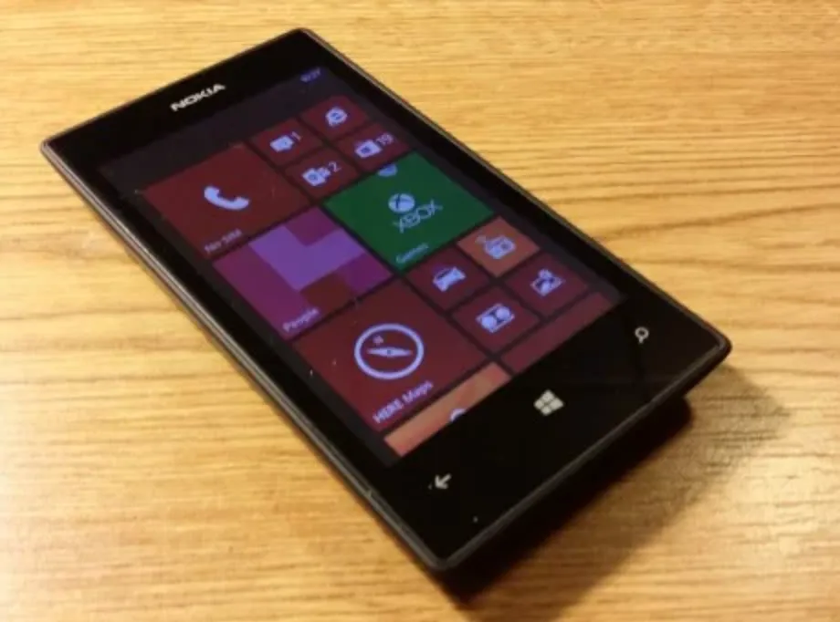 A Nokia Lumia 520 with the Windows Phone live tiles on screen